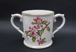 A Royal Worcester loving cup, transfer and infil decorated with flower blossoms, 13.