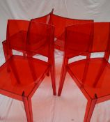 A set of four red injected polycarbonate Gyza stacking dining chairs CONDITION REPORT: