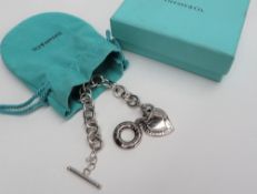 WITHDRAWN - A silver Tiffany bracelet with oval links, a T bar and two hearts, 18cm long,