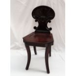 A Regency mahogany hall chair, with a shell shaped scrolling back,