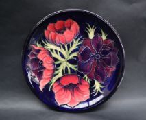 A Moorcroft pottery plate decorated in the Clematis pattern,