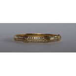 An 18ct yellow gold diamond set hinged bangle, set with two rows of brilliant cut diamonds,