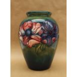 A Moorcroft pottery vase, decorated in the anemone pattern to a green ground,