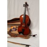 A Violin with two piece back and ebonised stringing, bears a label for John Betts,