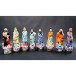 A set of eight Chinese porcelain figures of Sages and immortals, on oval bases,