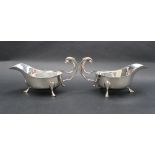 A Pair of George VI silver sauce boats with scalloped edge and three legs with pad feet and
