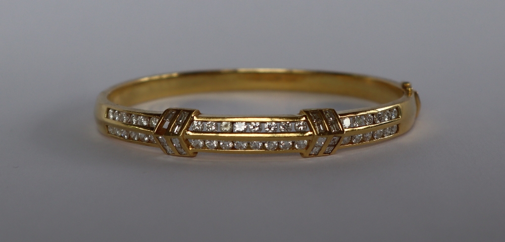 An 18ct yellow gold diamond set hinged bangle, set with two rows of brilliant cut diamonds, - Image 2 of 4