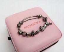A Pandora bracelet set with numerous charms,