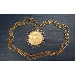 A George V gold half sovereign, dated 1915, in a 9ct gold mount on a 9ct gold chain,