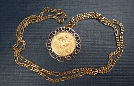 A George V gold half sovereign, dated 1915, in a 9ct gold mount on a 9ct gold chain,