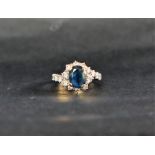 A sapphire and diamond ring, the oval faceted sapphire,