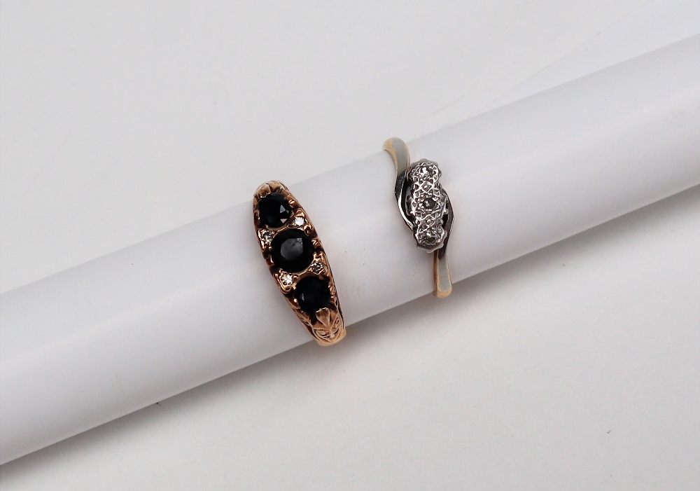 An 18ct gold three stone diamond ring, together with a sapphire and diamond ring,