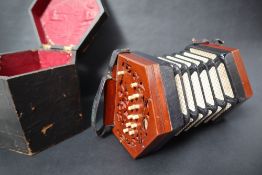 A Lachenal & Co concertina, with twenty three bone buttons to pierced mahogany ends,