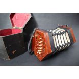 A Lachenal & Co concertina, with twenty three bone buttons to pierced mahogany ends,