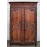 A French Louis XVI Normandy oak armoire the ribbon wound cavetto cornice with a swag frieze above