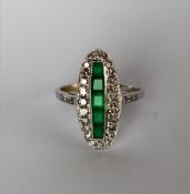 An emerald and diamond ring, of oval form,