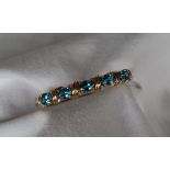 A 14ct yellow gold blue topaz and diamond set hinged bangle,