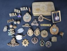 A Princess Mary gift fund brass box, together with a collection of military cap badges,