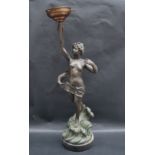 A 20th century spelter table lamp in the form of a semi naked female rising from the waves holding