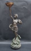 A 20th century spelter table lamp in the form of a semi naked female rising from the waves holding