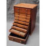 A mahogany table top coin collectors cabinet with ten drawers with divisions to the interior,