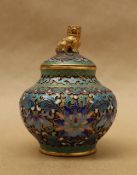 A cloisonne enamel vase and cover with a dog of foo surmount,