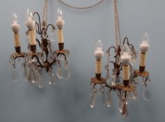 A pair of gilt metal three branch lustre drop wall lights,