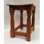 A Mouseman oak joint Stool by Robert 'MOUSEMAN' Thompson (1876-1955), with an oak dished top,