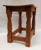 A Mouseman oak joint Stool by Robert 'MOUSEMAN' Thompson (1876-1955), with an oak dished top,