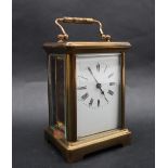 A French brass carriage clock, the rectangular dial with Roman numerals,
