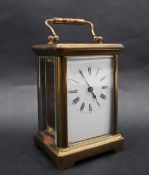A French brass carriage clock, the rectangular dial with Roman numerals,