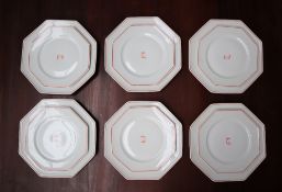 A Royal Limoges part dinner set, with an orange line border, and cypher to the centre,