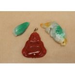A Jade lotus bud pendant together with a jadeite fish and a jadeite buddha pendant