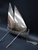 A continental white metal boat with twin sails and oars, marked 800,