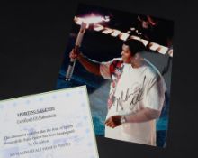 Boxing - A colour photograph of Muhammad Ali signed in black pen "Muhammad Ali", 25 x 20cm,