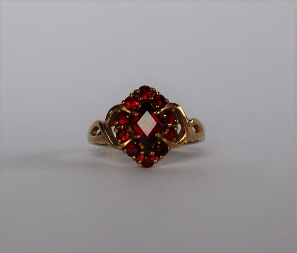 A 9ct yellow gold garnet cluster ring, set with a pointed central garnet and round faceted garnets, - Image 2 of 4