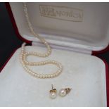 A graduated pearl necklace to a white metal clasp,