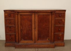 A late 19th century oak breakfront linen cupboard with a pair of cupboard doors enclosing linen