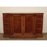 A late 19th century oak breakfront linen cupboard with a pair of cupboard doors enclosing linen