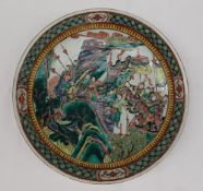 A Cantonese porcelain charger, decorated with warriors amongst trees,