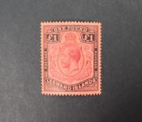 A Leeward Islands 1928 £1 purple and black/red unused stamp,
