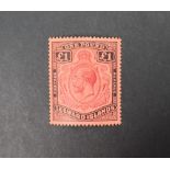 A Leeward Islands 1928 £1 purple and black/red unused stamp,