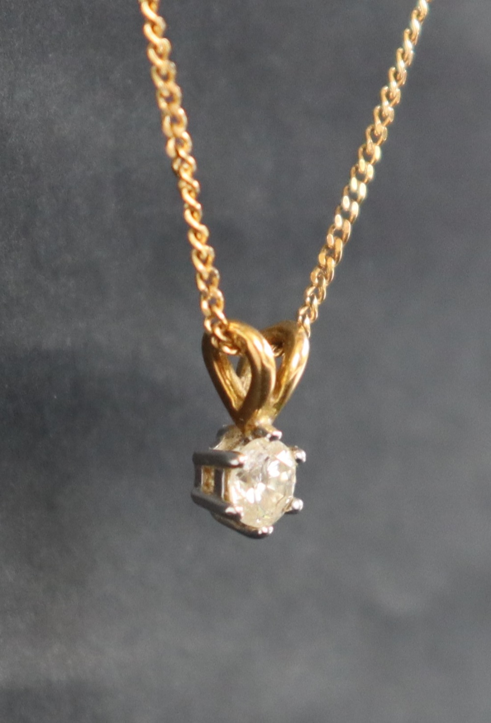 A diamond pendant, the round brilliant cut diamond approximately 0.