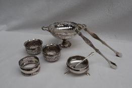 A George V silver twin handled pedestal dish, London, 1926, together with silver sugar nips,