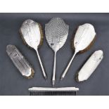 A George V silver part dressing table set including two hair brushes,