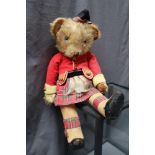 A Merrythought Bingie teddy bear dressed as a highlander in corduroy jacket,