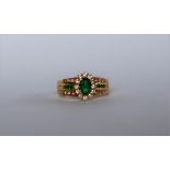A 14ct yellow gold emerald and diamond ring,
