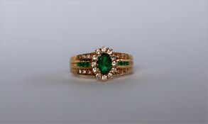 A 14ct yellow gold emerald and diamond ring,