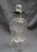 An Edward VII silver topped decanter,