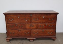 An 18th century oak coffer, in the form of a dresser base,